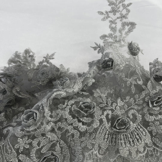 Close-up of a  floral lace trim with embroidered  3D rose motifs and delicate mesh texture in a silver color. Lace USA #21856W