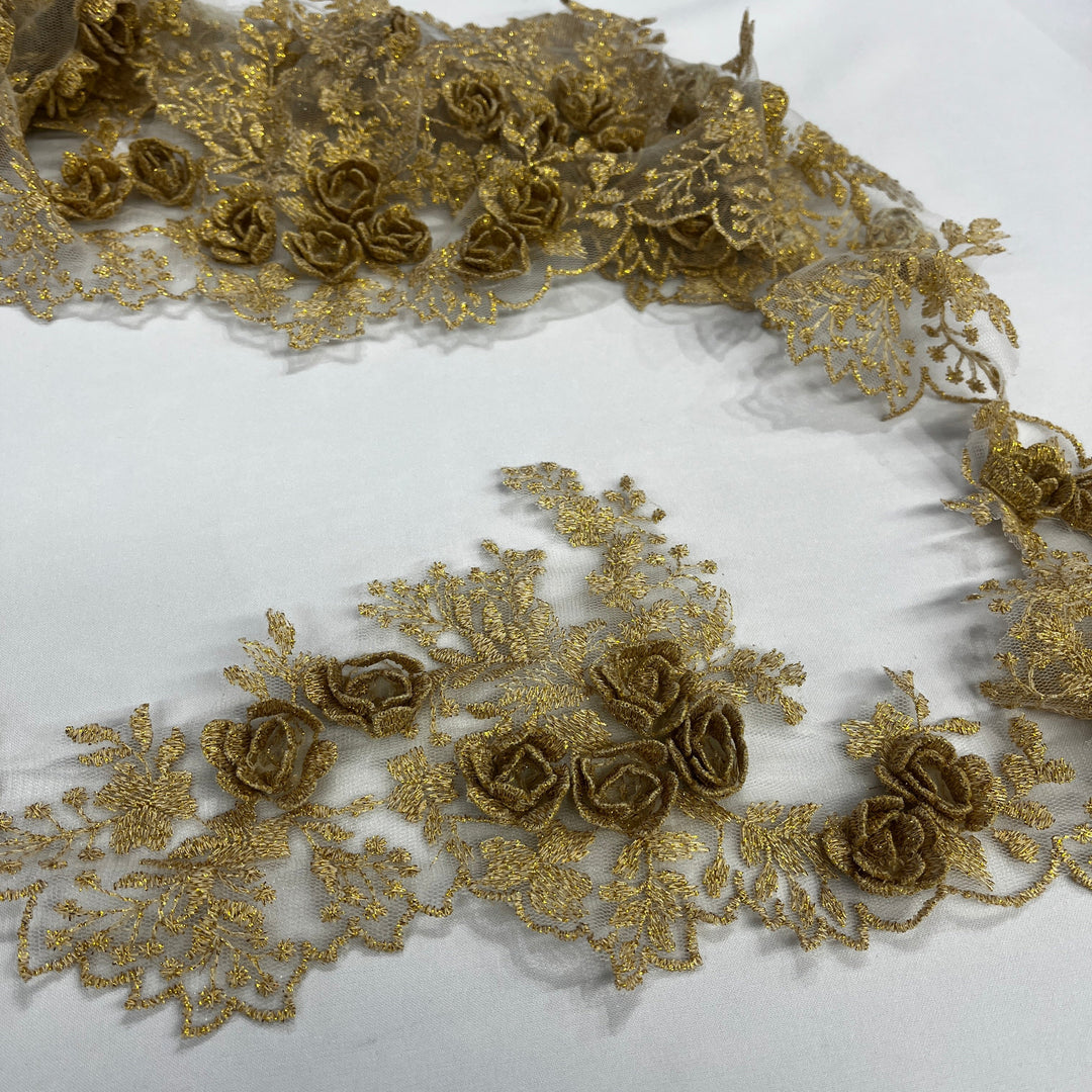 Gold lace trim with 3D rose motifs embroidered with metalic thread on 100% polyester net mesh,, featuring one flat unrolled length and one gathered bundle on a white background. LaceUSA #21853W
