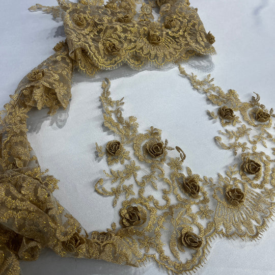 Gold floral lace fabric with embroidered 3D rose motifs and net mesh, laid out on a white background. Lace USA #21856W