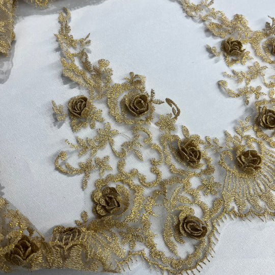 Gold floral lace trimming  with  embroidered 3D rose motifs on a white fabric background. Lace USA #21856W