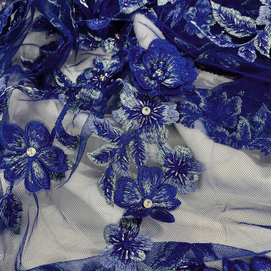 Close-up of Lace USA GD-1613 3D royal blue floral lace with bead and rhinestone embellishments, highlighting multicolor flowers—ideal for gowns