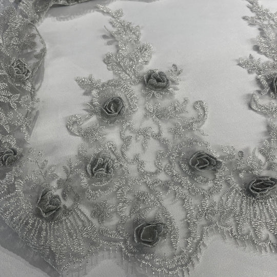 Close-up of a silver lace trim with intricate silver 3D rose embroidery sew with metalic thread. LaceUSA #21856W