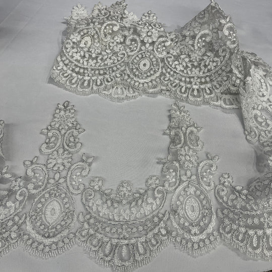 White with silver cording floral lace trim with ornate embroidery and scalloped edging, displayed on a white background.  Lace USA 96794W 