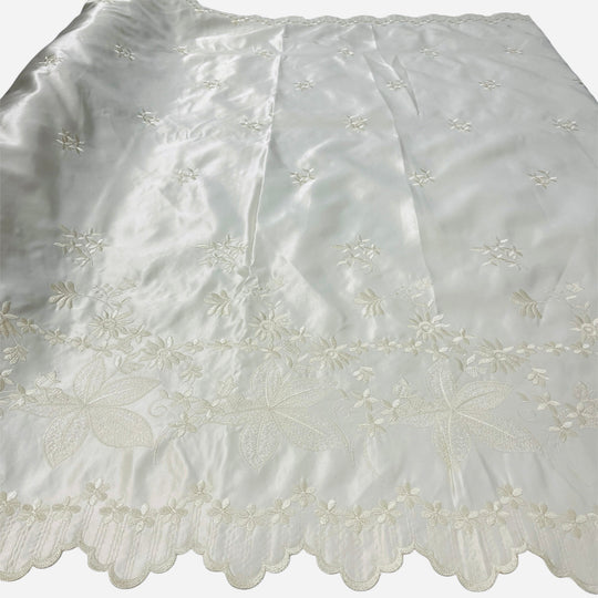 champagne_satin_fabric_with_embroidered_floral_patterns_Lace_USA_31051Ssatin fabric with delicate floral embroidery and a scalloped lace border, laid flat against a white background.