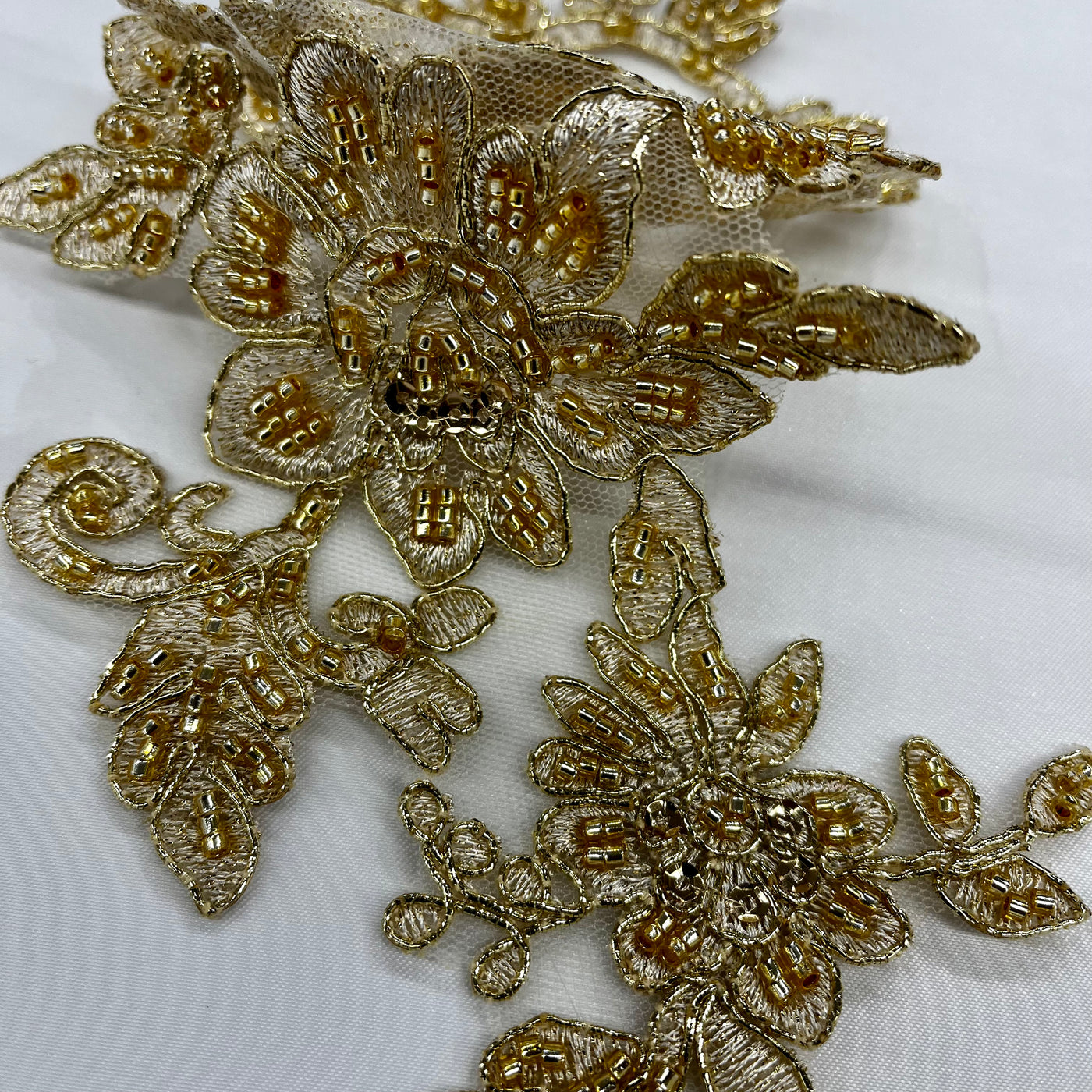 Beaded & Corded Silver Floral Appliqué Lace Embroidered on 100% Polyester Organza or Net Mesh. This can be applied to Theatrical dance ballroom costumes, bridal dresses, bridal headbands endless possibilities. Sold By Pair. Lace Usa